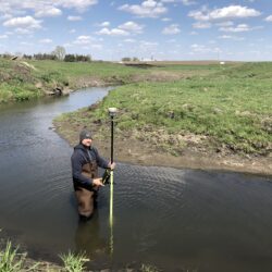 man standing in Iowa stream